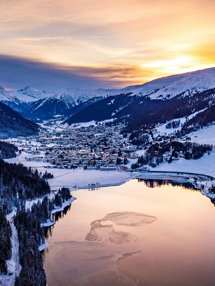 Lake Davos and snow-covered mountains at sunset