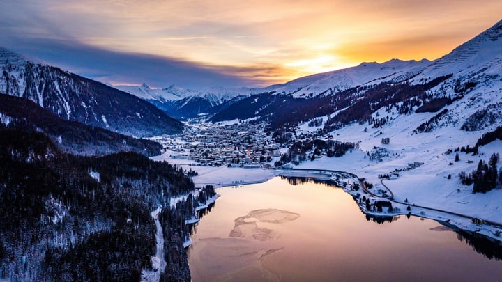 Lake Davos and snow-covered mountains at sunset